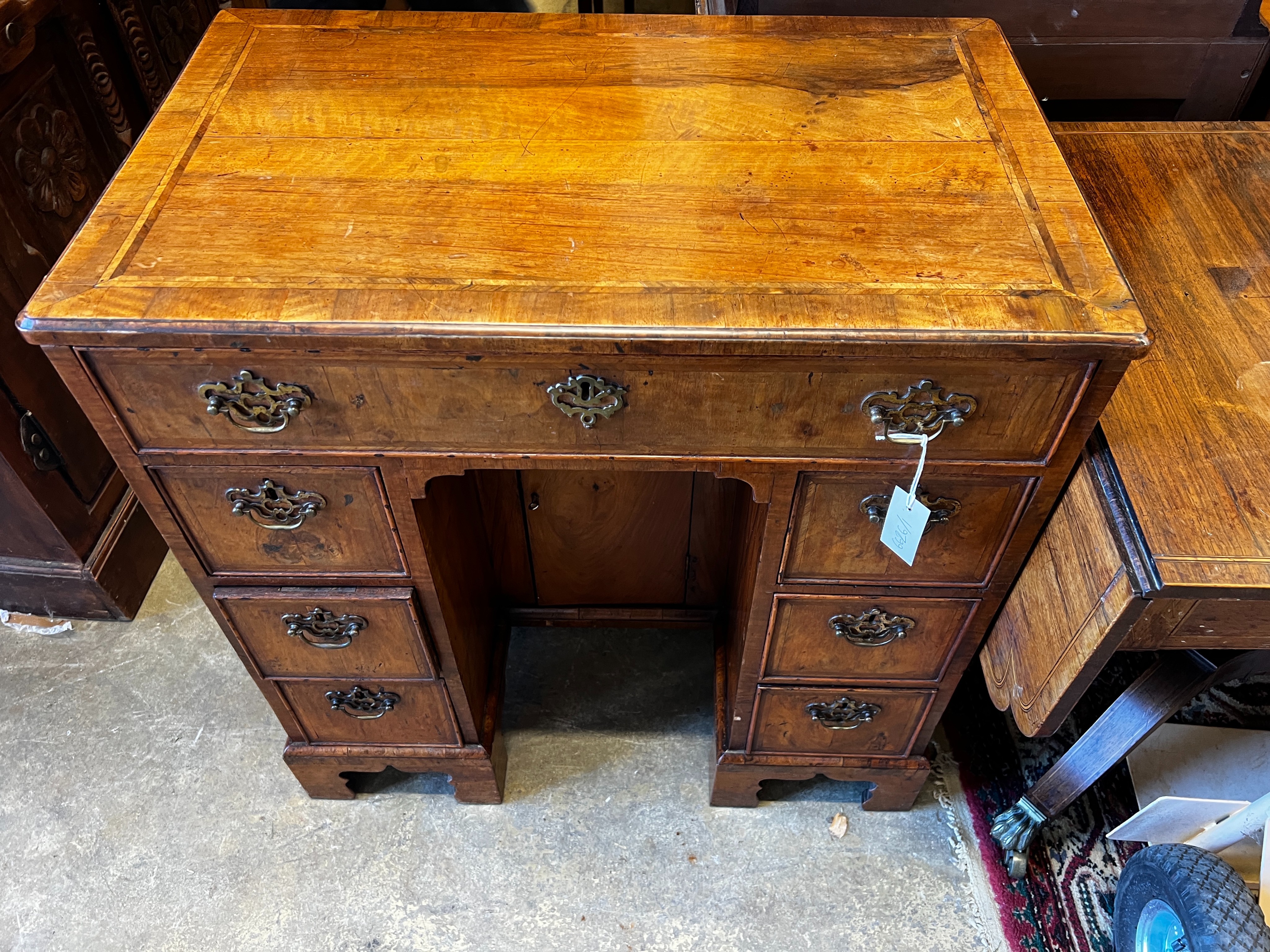 An 18th century feather banded walnut kneehole desk, length 78cm, depth 49cm, height 81cm